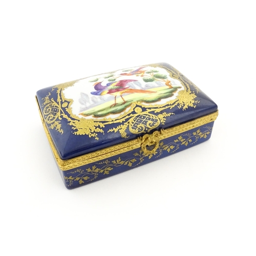 82 - A French porcelain box of rectangular form the cobalt blue ground with gilt decoration, the lid with... 