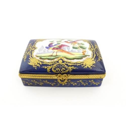 82 - A French porcelain box of rectangular form the cobalt blue ground with gilt decoration, the lid with... 