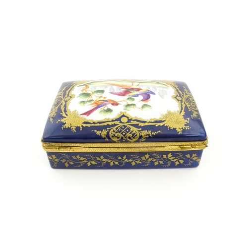 82 - A French porcelain box of rectangular form the cobalt blue ground with gilt decoration, the lid with... 