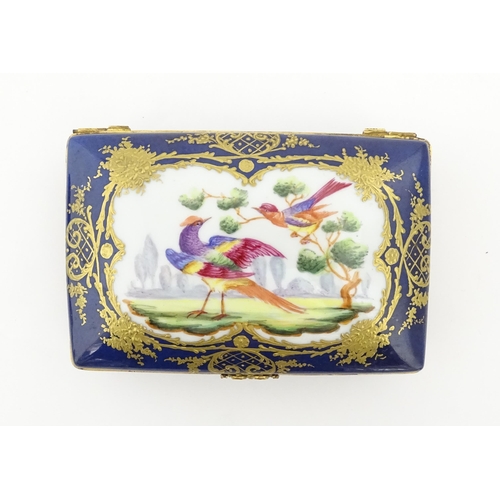 82 - A French porcelain box of rectangular form the cobalt blue ground with gilt decoration, the lid with... 