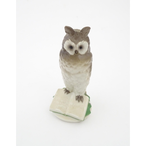 85 - A Nymphenburg model of an owl perched upon a book with the motto In Arte Voluptas. Marked under Nymp... 