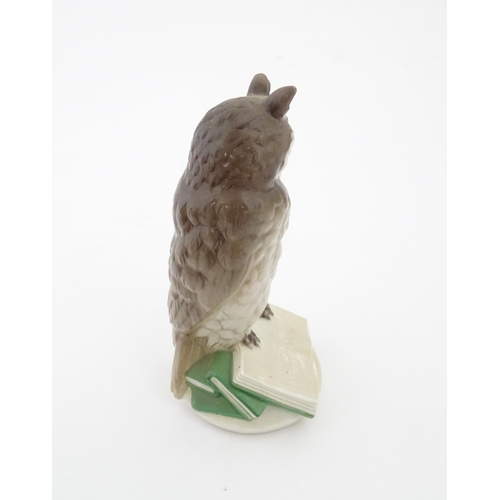 85 - A Nymphenburg model of an owl perched upon a book with the motto In Arte Voluptas. Marked under Nymp... 