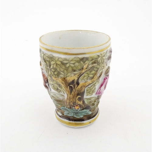 87 - A Continental coffee cup decorated in relief with animals in a landscape. Marked under with Capodimo... 