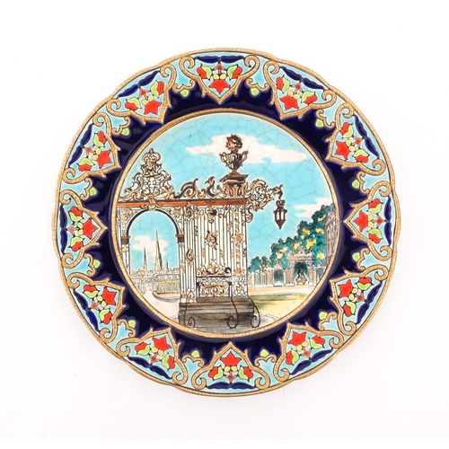 91 - A Longwy plate decorated in enamels depicting the Stanislas Gate of Nancy, France. Approx. 10