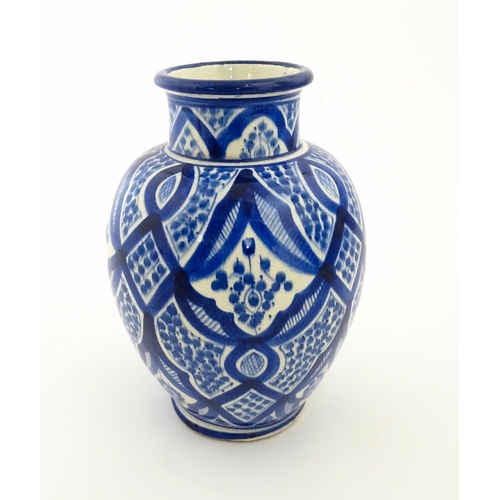 92 - A Continental blue and white vase of baluster form with brushwork decoration. Approx. 9 1/4