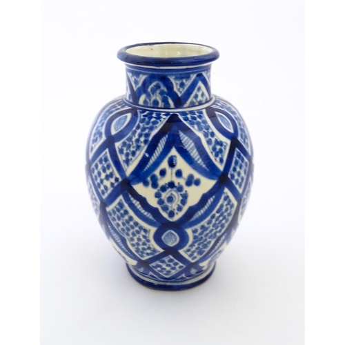 92 - A Continental blue and white vase of baluster form with brushwork decoration. Approx. 9 1/4