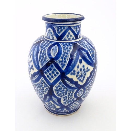 92 - A Continental blue and white vase of baluster form with brushwork decoration. Approx. 9 1/4