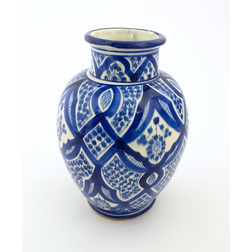 92 - A Continental blue and white vase of baluster form with brushwork decoration. Approx. 9 1/4