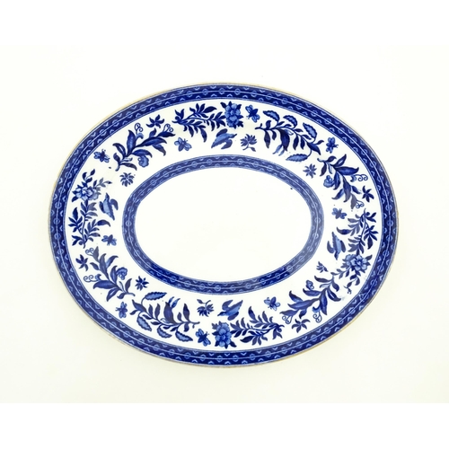 94 - A Charles Ford blue and white plate decorated with flowers, foliage, birds and insects. Marked under... 