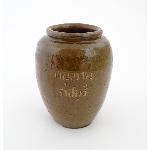 96 - A stoneware vase / pot of tapering form with script detail. Approx. 6 1/4