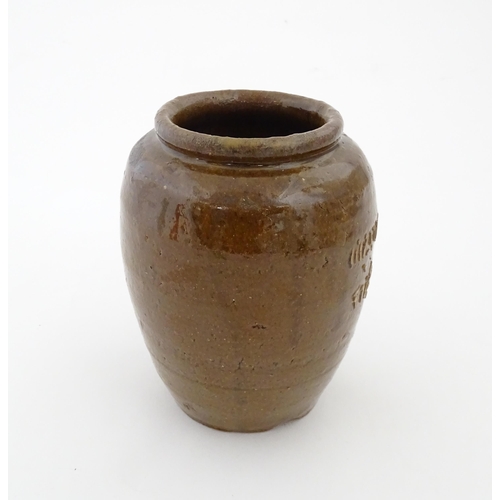 96 - A stoneware vase / pot of tapering form with script detail. Approx. 6 1/4