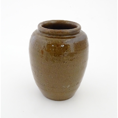 96 - A stoneware vase / pot of tapering form with script detail. Approx. 6 1/4