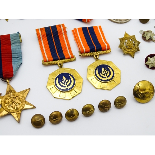 924 - Militaria : a quantity of 20thC medals and insignia,  comprising two WWI campaign medals to Gnr. W. ... 