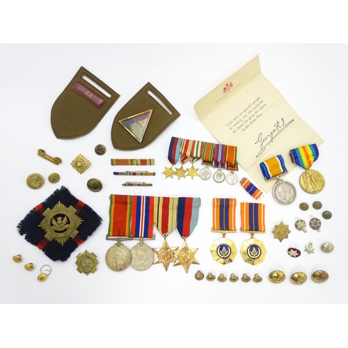 924 - Militaria : a quantity of 20thC medals and insignia,  comprising two WWI campaign medals to Gnr. W. ... 