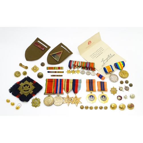 924 - Militaria : a quantity of 20thC medals and insignia,  comprising two WWI campaign medals to Gnr. W. ... 