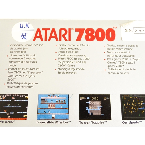 956 - Toys: An Atari 7800 video game console. Together with games cartridges comprising Jinks, Xevious, Po... 