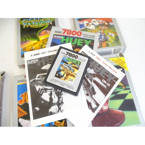 956 - Toys: An Atari 7800 video game console. Together with games cartridges comprising Jinks, Xevious, Po... 