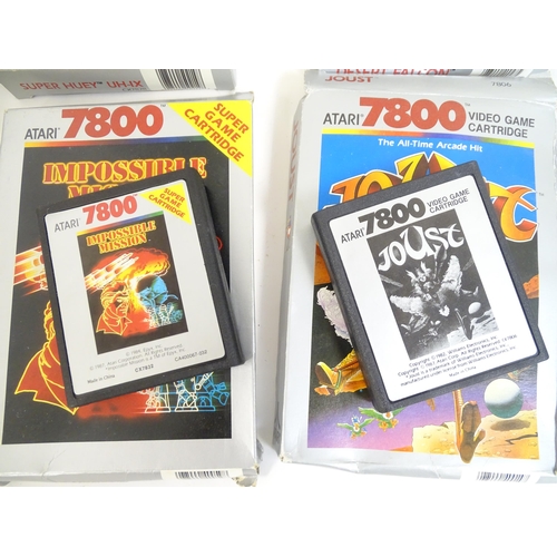 956 - Toys: An Atari 7800 video game console. Together with games cartridges comprising Jinks, Xevious, Po... 