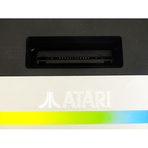 956 - Toys: An Atari 7800 video game console. Together with games cartridges comprising Jinks, Xevious, Po... 