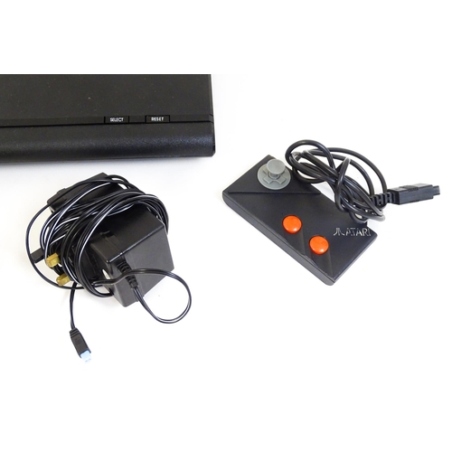 956 - Toys: An Atari 7800 video game console. Together with games cartridges comprising Jinks, Xevious, Po... 