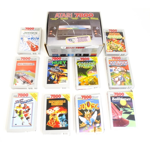 956 - Toys: An Atari 7800 video game console. Together with games cartridges comprising Jinks, Xevious, Po... 