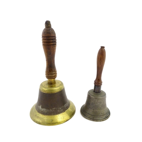 1073 - A 20thC hand bell with turned wooden handle. Together with another smaller example. Largest approx. ... 