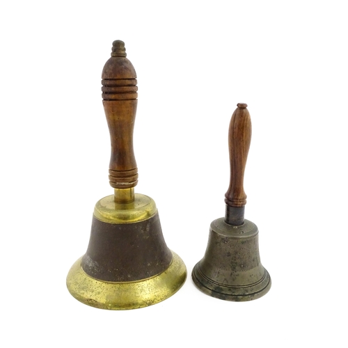 1073 - A 20thC hand bell with turned wooden handle. Together with another smaller example. Largest approx. ... 