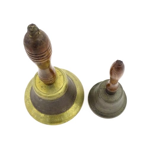 1073 - A 20thC hand bell with turned wooden handle. Together with another smaller example. Largest approx. ... 