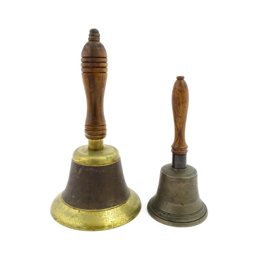 1073 - A 20thC hand bell with turned wooden handle. Together with another smaller example. Largest approx. ... 