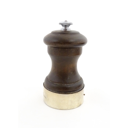 1173 - A 20thC turned wooden pepper mill / grinder with silver mount hallmarked Birmingham 1969, maker J. B... 