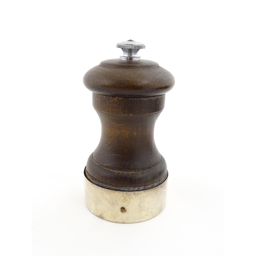 1173 - A 20thC turned wooden pepper mill / grinder with silver mount hallmarked Birmingham 1969, maker J. B... 