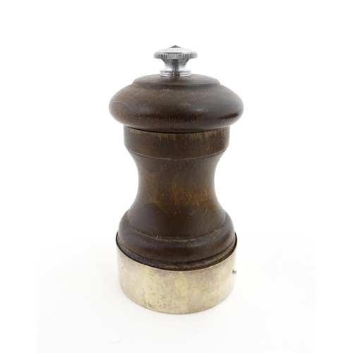 1173 - A 20thC turned wooden pepper mill / grinder with silver mount hallmarked Birmingham 1969, maker J. B... 