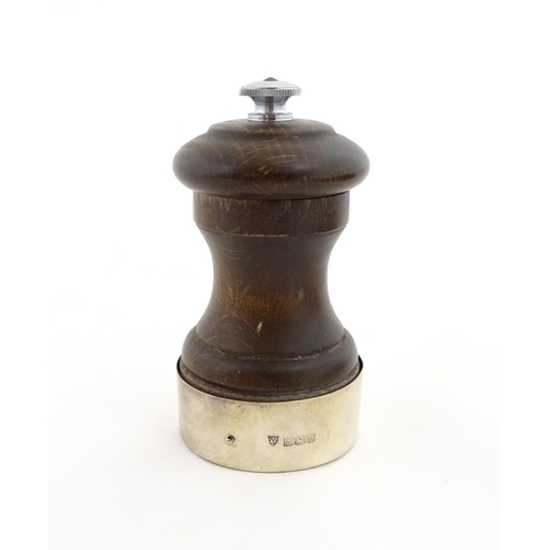 1173 - A 20thC turned wooden pepper mill / grinder with silver mount hallmarked Birmingham 1969, maker J. B... 