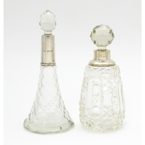 200A - Two cut glass scent / perfume bottles with silver mounts, one hallmarked Birmingham 1921, maker A J ... 