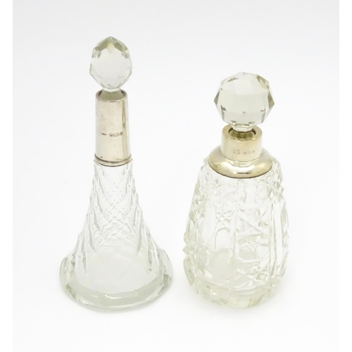 200A - Two cut glass scent / perfume bottles with silver mounts, one hallmarked Birmingham 1921, maker A J ... 