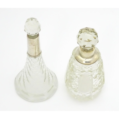 200A - Two cut glass scent / perfume bottles with silver mounts, one hallmarked Birmingham 1921, maker A J ... 