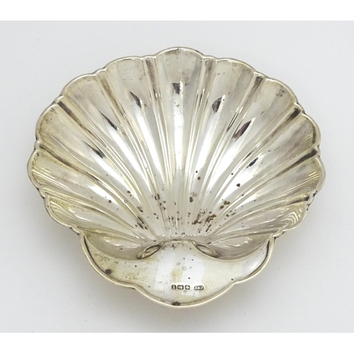 261 - A silver butter dish of scallop shell form hallmarked Sheffield 1915, maker C. W. Fletcher & Son Ltd... 