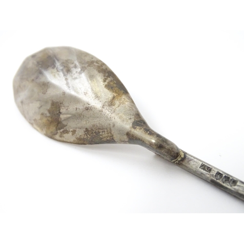 254 - A silver replica of a Roman Christening spoon, indistinctly marked. Approx. 8 1/4