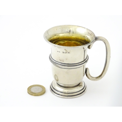 255 - A silver mug with loop handle and gilded interior, hallmarked Birmingham 1925, maker Napper & Davenp... 