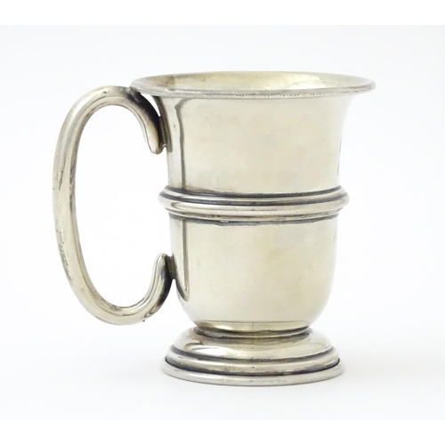 255 - A silver mug with loop handle and gilded interior, hallmarked Birmingham 1925, maker Napper & Davenp... 