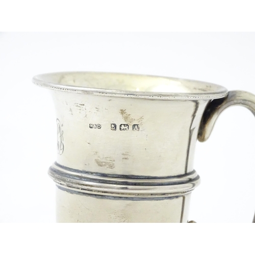 255 - A silver mug with loop handle and gilded interior, hallmarked Birmingham 1925, maker Napper & Davenp... 