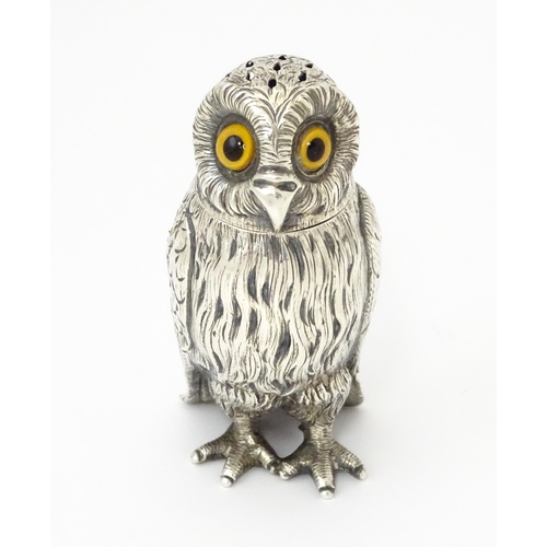 A Victorian silver novelty pepperette modelled as an owl with glass eyes, hallmarked London 1853, maker Daniel & Charles Houle. Approx. 3 1/2" high