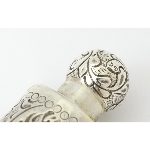 342 - A silver scent bottle / flask with embossed detail, hallmarked London 1883, maker SC/ Approx 10