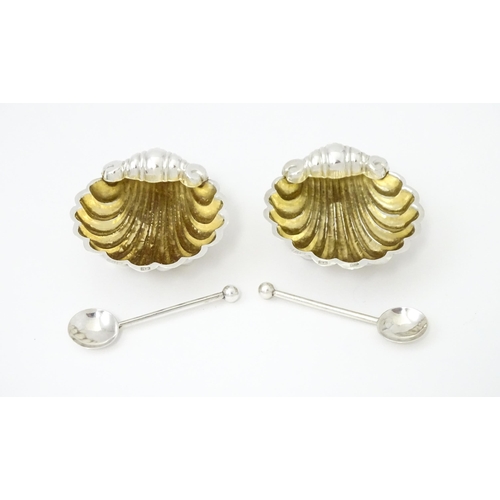 358 - A pair of silver salts of scallop shell form with gilded interiors with two salt spoons. All hallmar... 