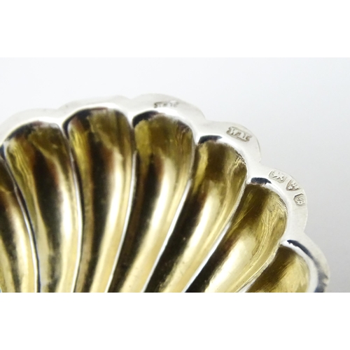 358 - A pair of silver salts of scallop shell form with gilded interiors with two salt spoons. All hallmar... 