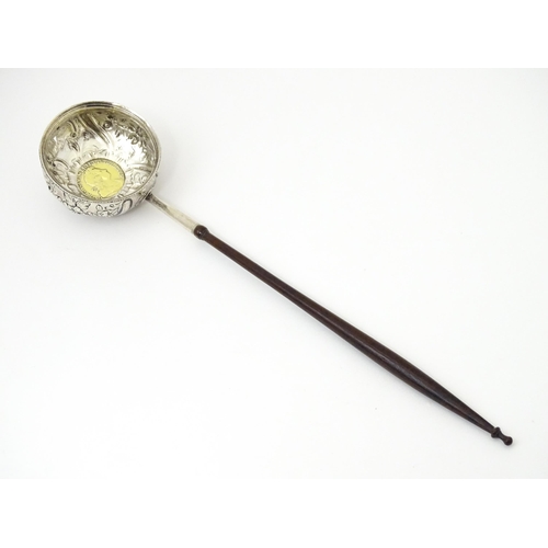 363 - A white metal punch ladle with coin style detail to bowl.  Approx 11