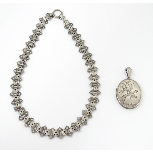 726 - A Victorian silver locket with engraved bird decoration together with a chain marked Sterling. The l... 