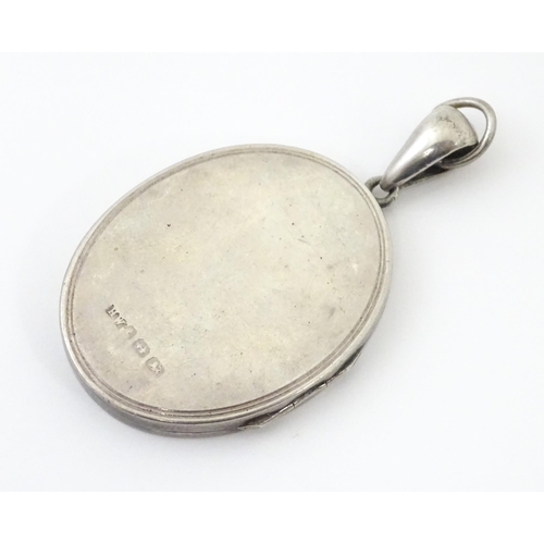 726 - A Victorian silver locket with engraved bird decoration together with a chain marked Sterling. The l... 