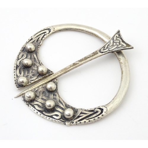 733 - A Scottish silver penannular brooch / pin with Celtic decoration.  Hallmarked  Glasgow 1941 maker He... 