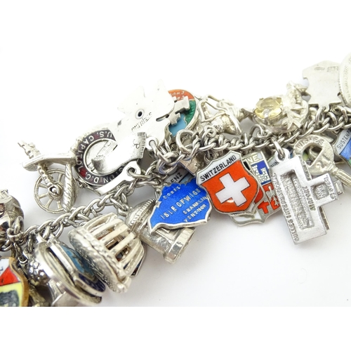 735 - A silver charm bracelet set with various silver, white metal and silver plate charms